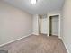 Inviting bedroom with carpet, closet, and open doorway leading to other rooms at 5828 Union Walk Dr, Union City, GA 30291