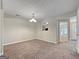 Open dining room features carpet, neutral walls, and transitions to other areas of the house with a view of the backyard at 5828 Union Walk Dr, Union City, GA 30291