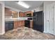 Efficient kitchen with wooden cabinets, modern appliances, and durable tile flooring creating a functional cooking space at 5828 Union Walk Dr, Union City, GA 30291