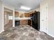 Well-lit kitchen with black appliances, wood cabinets, and tile floors, open to a view of additional living space at 5828 Union Walk Dr, Union City, GA 30291
