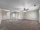 Large living room with a ceiling fan, carpeted flooring, and natural light, great for comfortable living and gatherings at 5828 Union Walk Dr, Union City, GA 30291
