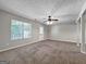 Bright living area with large window, carpeted floor, and ceiling fan, offering a comfortable and inviting atmosphere at 5828 Union Walk Dr, Union City, GA 30291