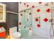 Modern bathroom featuring shower with decorative tile, a floating vanity, and contemporary fixtures at 242 Kirkley Rd, Tyrone, GA 30290