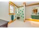 Modern bathroom with a glass-enclosed shower featuring decorative turquoise tiles and wood trim at 242 Kirkley Rd, Tyrone, GA 30290