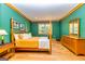 Spacious bedroom with a four-poster bed, hardwood floors, and large windows for natural light at 242 Kirkley Rd, Tyrone, GA 30290
