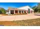 Wide view of a red home exterior, covered entry, landscaped yard, and separate garage at 242 Kirkley Rd, Tyrone, GA 30290