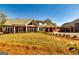 Expansive home exterior featuring a well manicured yard, covered porch, and a separate garage at 242 Kirkley Rd, Tyrone, GA 30290