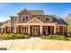 Stunning exterior featuring well-maintained landscaping, covered entryway, and attractive architectural details at 242 Kirkley Rd, Tyrone, GA 30290
