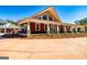 A beautiful home featuring stone columns, a covered porch, and an immaculately manicured lawn at 242 Kirkley Rd, Tyrone, GA 30290