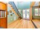 Bright foyer showcasing wooden floors, black metal staircase and artistic glass-paneled front door at 242 Kirkley Rd, Tyrone, GA 30290