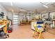 Large garage with multiple work benches, overhead lighting, and door perfect for the hobbyist at 242 Kirkley Rd, Tyrone, GA 30290