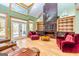 Inviting living room with large marble fireplace, built-in shelving, and a beautiful view of the outdoors at 242 Kirkley Rd, Tyrone, GA 30290