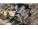 Birds eye view of the roof, driveway, and trees surrounding the home, showing its layout and features at 5479 Dorsett Shoals Rd, Douglasville, GA 30135