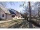 Spacious backyard with lush grass, mature trees, and a patio area, ideal for outdoor activities at 5479 Dorsett Shoals Rd, Douglasville, GA 30135