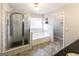 Modern bathroom with tile flooring, shower, bath and bright lighting at 5479 Dorsett Shoals Rd, Douglasville, GA 30135