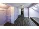 Spacious bedroom with light purple walls, gray floors and a walk-in closet at 5479 Dorsett Shoals Rd, Douglasville, GA 30135