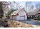 Attached garage featuring a white door, painted trim, and adjacent driveway at 5479 Dorsett Shoals Rd, Douglasville, GA 30135