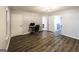 Bright living room featuring gray walls, light fixture, and a workstation area with a desk at 5479 Dorsett Shoals Rd, Douglasville, GA 30135
