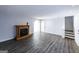 Spacious living room with gray walls, wood floors, and a classic fireplace at 5479 Dorsett Shoals Rd, Douglasville, GA 30135