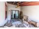 Cozy patio with ceiling fan, wicker furniture and sliding glass doors at 5479 Dorsett Shoals Rd, Douglasville, GA 30135