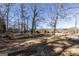 Side yard showcasing mature trees and landscaping, providing shade and privacy to the property at 5479 Dorsett Shoals Rd, Douglasville, GA 30135