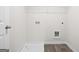 Bright laundry room features hookups, utility sink and wood look flooring at 11527 Kimberly Way # 8, Hampton, GA 30228