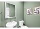 Stylish half-bathroom with a pedestal sink, contemporary mirror, and modern decor at 11521 Kimberly Way # 5, Hampton, GA 30228