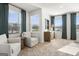 Bedroom with large windows offering outdoor views, light-colored carpet, and chairs for a relaxing seating area at 11521 Kimberly Way # 5, Hampton, GA 30228