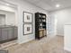 Hallway with neutral carpet, two framed pictures, a bookcase and a bathroom across the hall at 11521 Kimberly Way # 5, Hampton, GA 30228