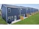 Back view of townhomes featuring a private yard, patio, and an air conditioning unit at 11517 Kimberly Way # 3, Hampton, GA 30228