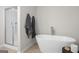 Luxurious bathroom featuring a standalone tub and a separate shower with white tiled walls and glass doors at 11517 Kimberly Way # 3, Hampton, GA 30228