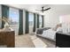 Bright bedroom with large windows, a modern bed, and serene green curtains, creating a relaxing and airy atmosphere at 11517 Kimberly Way # 3, Hampton, GA 30228