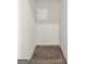 Small empty closet with wood-look flooring at 11517 Kimberly Way # 3, Hampton, GA 30228