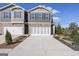 Charming townhome featuring a brick and gray facade, a two-car garage, and professional landscaping at 11517 Kimberly Way # 3, Hampton, GA 30228