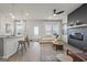 Open-concept living area with modern furnishings, a ceiling fan, and an eat-in kitchen island at 11517 Kimberly Way # 3, Hampton, GA 30228