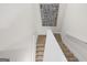 Carpeted stairway with white handrail and modern artwork at 11517 Kimberly Way # 3, Hampton, GA 30228