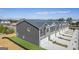 Newly built grey siding townhomes with a well-maintained landscape and private garages at 11517 Kimberly Way # 3, Hampton, GA 30228