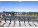 Aerial view of newly built townhomes with modern gray siding, asphalt shingles and private garages at 11517 Kimberly Way # 3, Hampton, GA 30228