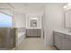 Elegant bathroom featuring a soaking tub, a glass-enclosed shower, and double vanities at 1705 Goodwin Dr # 28, Hampton, GA 30228