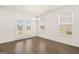 Bright dining area with hardwood floors, french doors to the backyard and modern lighting at 1705 Goodwin Dr, Hampton, GA 30228