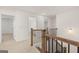 Upper hallway featuring wood railing and access to multiple bedrooms and bathrooms at 1705 Goodwin Dr, Hampton, GA 30228