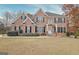 Beautiful two-story brick home featuring black shutters, a well-kept lawn, and a welcoming front entrance at 355 Woodbyne Dr, Fayetteville, GA 30214