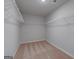 Spacious walk-in closet featuring neutral carpet and adjustable wire shelving for optimal organization at 1709 Goodwin Dr # 29, Hampton, GA 30228