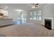 Spacious living room with a fireplace, large windows, and an open layout to the kitchen area at 1709 Goodwin Dr # 29, Hampton, GA 30228