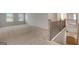 Spacious loft area with neutral carpet, natural light, and views of the staircase and lower level at 1709 Goodwin Dr # 29, Hampton, GA 30228