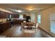 Kitchen with dark brown cabinets, a round table and chairs, and laminate wood flooring at 306 Blackfoot Trl, Villa Rica, GA 30180