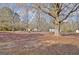 View of backyard with scattered trees and fallen leaves at 435 Crabapple Rd, Fayetteville, GA 30215