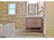 Updated bathroom with wood accent wall, matching wood vanity, and stylish tile flooring at 435 Crabapple Rd, Fayetteville, GA 30215