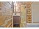 This is a unique bathroom with paneled walls, modern vanity, and an open doorway to the walk-in closet at 435 Crabapple Rd, Fayetteville, GA 30215