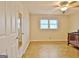 Well-lit room featuring parquet floors, ceiling fan, and window, accentuated by a mirrored closet door at 435 Crabapple Rd, Fayetteville, GA 30215